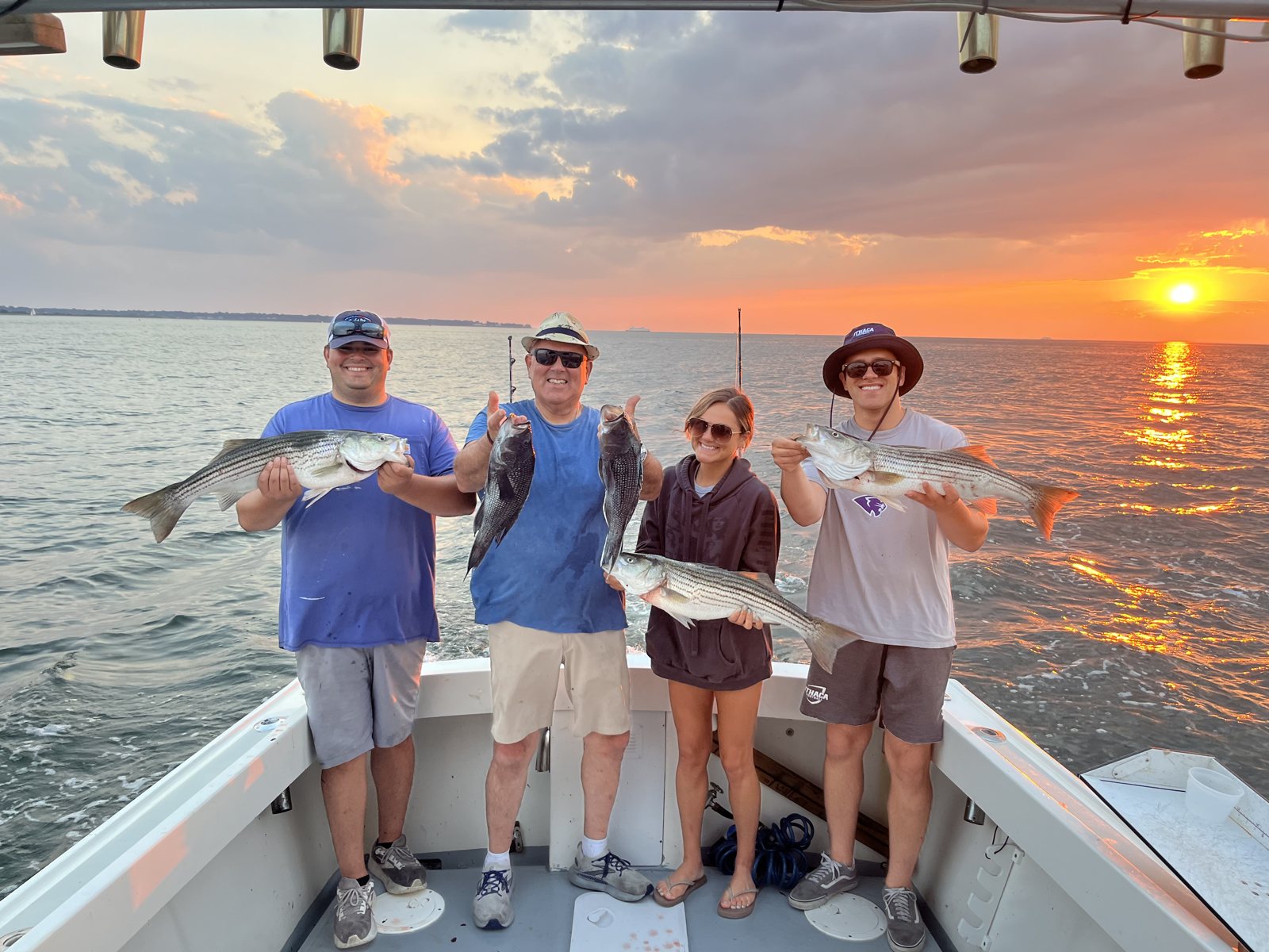Anglers with their catch at sunset on the Long Island Sound